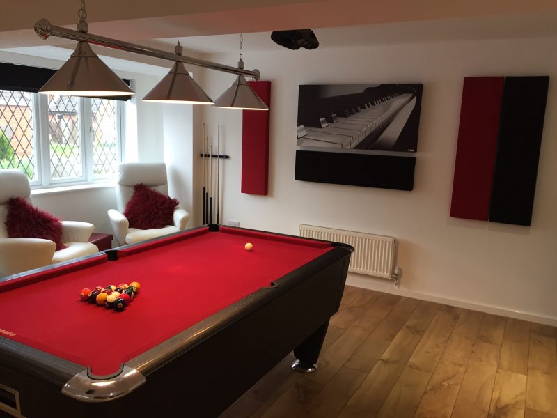 GIK Acoustics acoustic panels and acoustic art panel above billiard table in room angled view